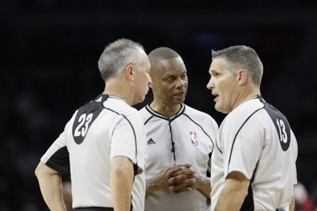 From left, referees Jason Phillips (23), Michael Smith, center, and Monty McCutchen (13) talk during the second half in Game 3 of a first-round NBA basketball playoff series between the Detroit Pistons and the Cleveland Cavaliers, Friday, April 22, 2016 in Auburn Hills, Mich. (AP Photo/Carlos Osorio)