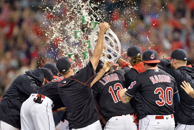 Sep 17, 2016; Cleveland, OH, USA; Cleveland Indians third baseman Jose Ramirez (11) celebrates with teammates after hitting a game-winning single during the tenth inning against the Detroit Tigers at Progressive Field. The Indians won 1-0. Mandatory Credit: Ken Blaze-USA TODAY Sports