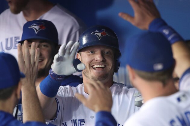 TORONTO, CANADA - SEPTEMBER 23: Josh Donaldson #20 of the Toronto Blue Jays is coongratulated by teammates in the dugout after hitting a two-run home run in the eighth inning during MLB game action against the New York Yankees on September 23, 2016 at Rogers Centre in Toronto, Ontario, Canada. (Photo by Tom Szczerbowski/Getty Images)