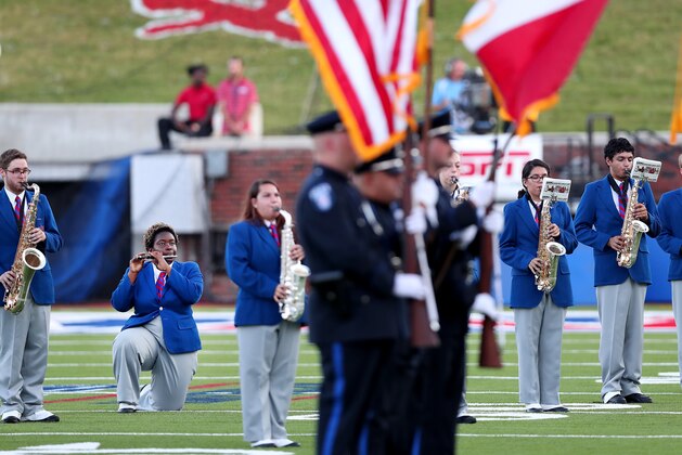 DALLAS, TX - SEPTEMBER 23:  A member of the against the Southern Methodist Mustangs marching band kneels during the playing of the national anthem before the Southern Methodist Mustangs take on the TCU Horned Frogs at Gerald J. Ford Stadium on September 23, 2016 in Dallas, Texas.  (Photo by Tom Pennington/Getty Images)