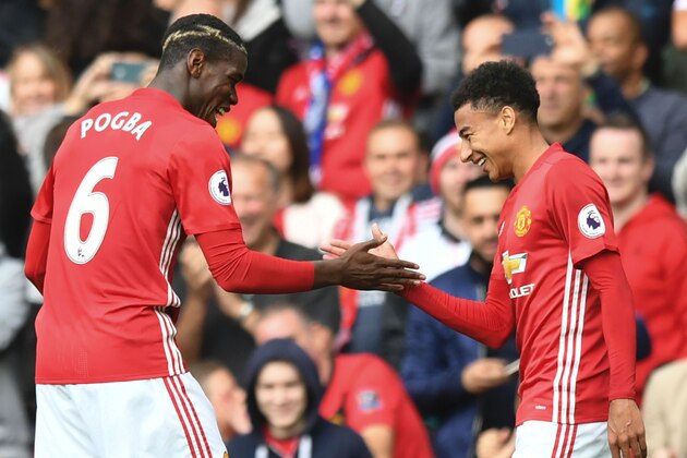 Manchester United's French midfielder Paul Pogba (L) and Manchester United's English midfielder Jesse Lingard (R) celebrate after Pogba scored their fourth goal during the English Premier League football match between Manchester United and Leicester City at Old Trafford in Manchester, north west England, on September 24, 2016. / AFP / ANTHONY DEVLIN / RESTRICTED TO EDITORIAL USE. No use with unauthorized audio, video, data, fixture lists, club/league logos or 'live' services. Online in-match use limited to 75 images, no video emulation. No use in betting, games or single club/league/player publications.  /         (Photo credit should read ANTHONY DEVLIN/AFP/Getty Images)