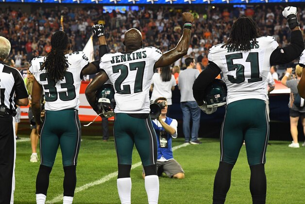 Sep 19, 2016; Chicago, IL, USA; Philadelphia Eagles defensive back Ron Brooks (33), strong safety Malcolm Jenkins (27) and defensive end Steven Means (51) raise their right hands up during the playing of the national anthem prior to the game against the Chicago Bears at Soldier Field. Mandatory Credit: Mike DiNovo-USA TODAY Sports