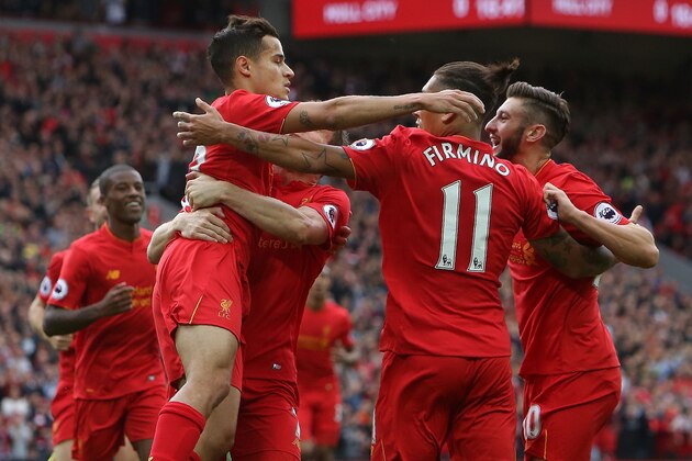 Liverpool's English midfielder Adam Lallana (R) is congratelated by teammates after scoring his team's first goal during the English Premier League football match between Liverpool and Hull City at Anfield in Liverpool, north west England on September 24, 2016. / AFP / Geoff CADDICK / RESTRICTED TO EDITORIAL USE. No use with unauthorized audio, video, data, fixture lists, club/league logos or 'live' services. Online in-match use limited to 75 images, no video emulation. No use in betting, games or single club/league/player publications.  /         (Photo credit should read GEOFF CADDICK/AFP/Getty Images)