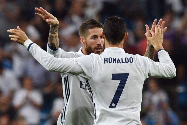 Real Madrid's defender Sergio Ramos (L) is congratulated by Real Madrid's Portuguese forward Cristiano Ronaldo after scoring a goal during the Spanish league football match Real Madrid CF vs Villarreal CF at the Santiago Bernabeu stadium in Madrid on September 21, 2016. / AFP / GERARD JULIEN        (Photo credit should read GERARD JULIEN/AFP/Getty Images)