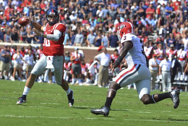 Sep 24, 2016; Oxford, MS, USA; Mississippi Rebels quarterback Chad Kelly (10) drops back to pass under pressure from Georgia Bulldogs linebacker Roquan Smith (3) during the first quarter of the game at Vaught-Hemingway Stadium. Mandatory Credit: Matt Bush-USA TODAY Sports