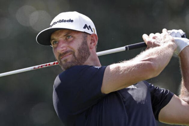 Dustin Johnson hits from the tee on the 14th hole during the third round of play at the Tour Championship golf tournament at East Lake Golf Club on Saturday, Sept. 24, 2016, in Atlanta. (AP Photo/John Bazemore)
