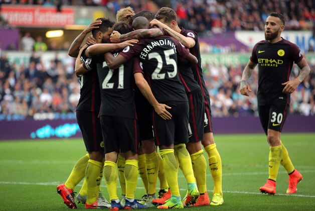 SWANSEA, WALES - SEPTEMBER 24: Sergio Aguero of Manchester City celebrates with team mates  his goal he scored from the penalty spot during the Premier League match between Swansea City and Manchester City at The Liberty Stadium on September 24, 2016 in Swansea, Wales. (Photo by Athena Pictures/Getty Images)
