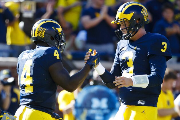 Sep 24, 2016; Ann Arbor, MI, USA; Michigan Wolverines running back De'Veon Smith (4) receives congratulations from quarterback Wilton Speight (3) after scoring a touchdown in the first quarter against the Penn State Nittany Lions at Michigan Stadium. Mandatory Credit: Rick Osentoski-USA TODAY Sports