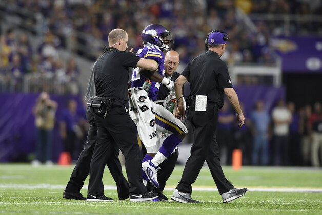 MINNEAPOLIS, MN - SEPTEMBER 18: Adrian Peterson #28 of the Minnesota Vikings is carried off the field by trainers in the third quarter of the game against the Green Bay Packers on September 18, 2016 at US Bank Stadium in Minneapolis, Minnesota. (Photo by Hannah Foslien/Getty Images)
