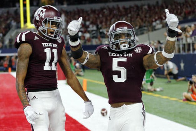 Texas A&M's Josh Reynolds (11) and running back Trayveon Williams (5) celebrate a touchdown run by Williams late in the second half of an NCAA college football game against Arkansas on Sunday, Sept. 25, 2016, in Arlington, Texas. Texas A&M won 45-24. (AP Photo/Tony Gutierrez)