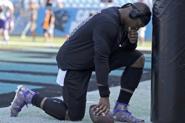 Carolina Panthers' Cam Newton pauses as he warms up before an NFL football game against the Minnesota Vikings in Charlotte, N.C., Sunday, Sept. 25, 2016. (AP Photo/Mike McCarn)