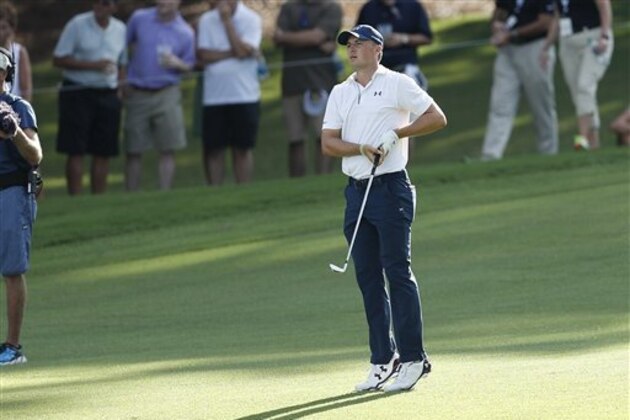 Jordan Spieth strains to see his ball after hitting from the fairway on the 18th hole during the second round of play at the Tour Championship golf tournament at East Lake Golf Club  Friday, Sept. 23, 2016, in Atlanta. (AP Photo/John Bazemore)