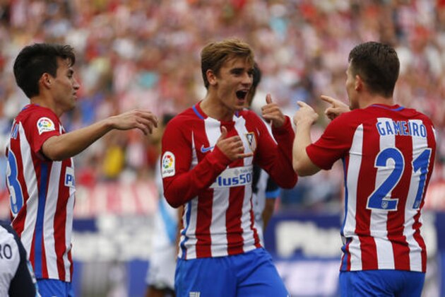 Atletico Madrid's Antoine Griezmann, centre, celebrates with teammates Kevin Gameiro, right, and Nicolas Gaitan after scoring the opening goal against Deportivo Coruna during the Spanish La Liga soccer match between Atletico Madrid and Deportivo at the Vicente Calderon stadium in Madrid, Sunday, Sept. 25, 2016. Griezmann scored once in Atletico's 1-0 victory. (AP Photo/Francisco Seco)