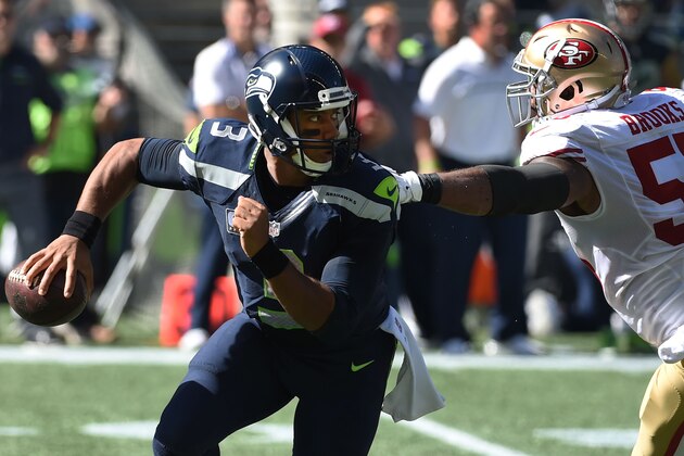 SEATTLE, WA - SEPTEMBER 25: Quarterback Russell Wilson #3 of the Seattle Seahawks runs out of the grasp of outside linebacker Ahmad Brooks #55 of the San Francisco 49ers the first quarter of the game at CenturyLink Field on September 25, 2016 in Seattle,Washington. (Photo by Steve Dykes/Getty Images)