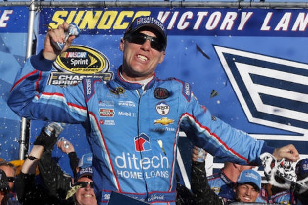 Kevin Harvick celebrates in Victory Lane after winning the NASCAR Sprint Cup Series auto race at New Hampshire Motor Speedway, Sunday, Sept. 25, 2016, in Loudon, N.H. (AP Photo/Jim Cole)