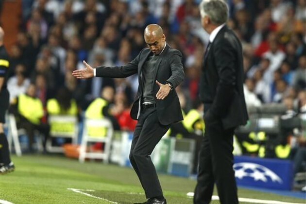 Bayern head coach Pep Guardiola, left, gestures to his players next to Real's coach Carlo Ancelotti during a first leg semifinal Champions League soccer match between Real Madrid and Bayern Munich at the Santiago Bernabeu stadium in Madrid, Spain, Wednesday, April 23, 2014. (AP Photo/Andres Kudacki)