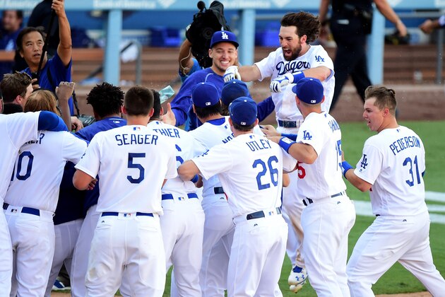 LOS ANGELES, CA - SEPTEMBER 25:  Charlie Culberson #6 of the Los Angeles Dodgers celebrates his solo homerun for a 4-3 win over the Colorado Rockies during the tenth inning at Dodger Stadium on September 25, 2016 in Los Angeles, California.  The Los Angeles Dodgers clinch the division with the win.  (Photo by Harry How/Getty Images)