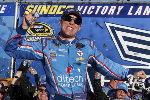 Kevin Harvick celebrates in Victory Lane after winning the NASCAR Sprint Cup Series auto race at New Hampshire Motor Speedway, Sunday, Sept. 25, 2016, in Loudon, N.H. (AP Photo/Jim Cole)