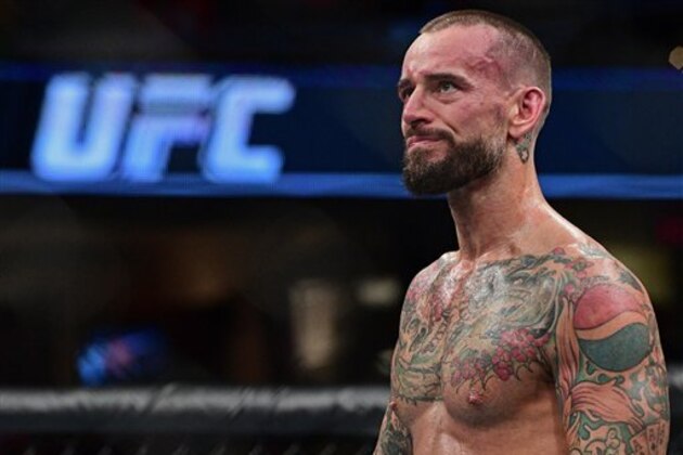 CM Punk stands in the octagon after being defeated by Mickey Gall during a welterweight bout at UFC 203 on Saturday, Sept. 10, 2016, in Cleveland.  (AP Photo/David Dermer)