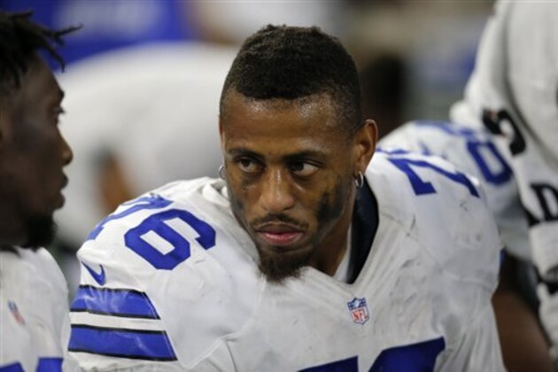 Dallas Cowboys' Greg Hardy (76) talks with teammates on the bench in the second half of an NFL football game against the Philadelphia Eagles on Sunday, Nov. 8, 2015, in Arlington, Texas. (AP Photo/Brandon Wade)