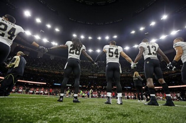 New Orleans Saints and Atlanta Falcons players form a unity demonstration on the field before an NFL football game in New Orleans, Monday, Sept. 26, 2016. (AP Photo/Gerald Herbert)