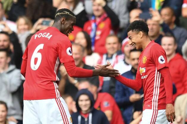 Manchester United's French midfielder Paul Pogba (L) and Manchester United's English midfielder Jesse Lingard (R) celebrate after Pogba scored their fourth goal during the English Premier League football match between Manchester United and Leicester City at Old Trafford in Manchester, north west England, on September 24, 2016. / AFP / ANTHONY DEVLIN / RESTRICTED TO EDITORIAL USE. No use with unauthorized audio, video, data, fixture lists, club/league logos or 'live' services. Online in-match use limited to 75 images, no video emulation. No use in betting, games or single club/league/player publications.  /         (Photo credit should read ANTHONY DEVLIN/AFP/Getty Images)