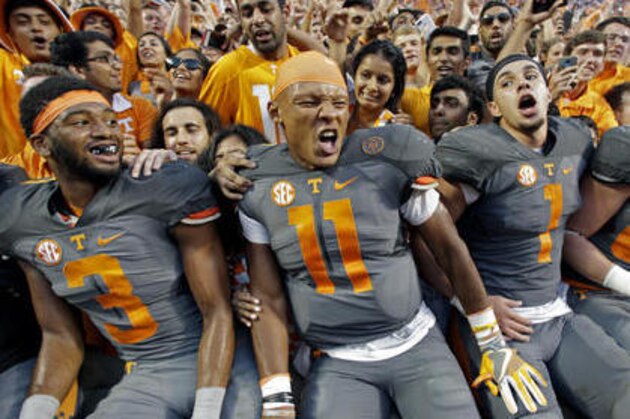 Tennessee quarterback Joshua Dobbs (11) celebrates with running back Jalen Hurd (1), wide receiver Josh Malone (3) and tight end Ethan Wolf (82) after an NCAA college football game against Florida, Saturday, Sept. 24, 2016, in Knoxville, Tenn. Tennessee won 38-28. (AP Photo/Wade Payne)