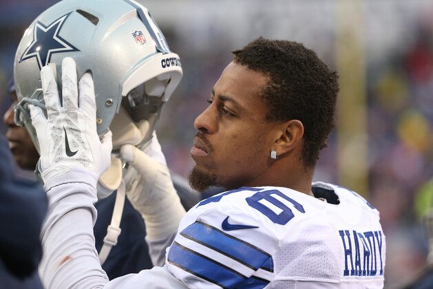 ORCHARD PARK, NY - DECEMBER 27: Greg Hardy #76 of the Dallas Cowboys puts on his helmet on the sideline against the Buffalo Bills during NFL game action at Ralph Wilson Stadium on December 27, 2015 in Orchard Park, New York. (Photo by Tom Szczerbowski/Getty Images)