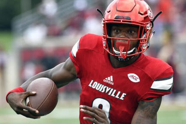 FILE - In this Sept. 17, 2016, file photo, Louisville's Lamar Jackson runs through an opening in the Florida State line during the first quarter of an NCAA college football game, in Louisville Ky. Lamar Jackson and No. 3 Louisville go from playing the main event last week to the side stage this week. The Cardinals head to Marshall after jumping into the national title race by tearing up Florida State at home last week.  (AP Photo/Timothy D. Easley, File)