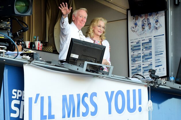 LOS ANGELES, CA - SEPTEMBER 25:  Los Angeles Dodgers announcer Vin Scully and his wife Sandra Hunt acknowedge the crowds applause for his 67 years of service after a 4-3 win over the Colorado Rockies at Dodger Stadium on September 25, 2016 in Los Angeles, California.  This was Scully's final home game as he will retire at the end of the season.  (Photo by Harry How/Getty Images)