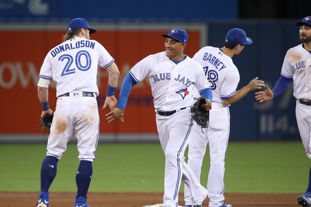 TORONTO, CANADA - SEPTEMBER 27: Ezequiel Carrera #3 of the Toronto Blue Jays celebrates their victory with Josh Donaldson #20 during MLB game action against the Baltimore Orioles on September 27, 2016 at Rogers Centre in Toronto, Ontario, Canada. (Photo by Tom Szczerbowski/Getty Images)