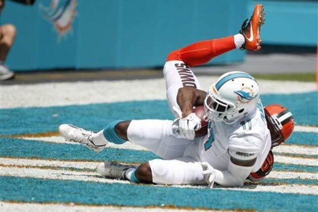 Miami Dolphins wide receiver DeVante Parker (11) scores a touchdown over Cleveland Browns cornerback Briean Boddy-Calhoun (20) during an NFL football game, Sunday, Sept. 25, 2016, in Miami Gardens, Fla. (AP Photo/Wilfredo Lee)