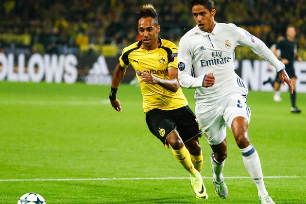 Dortmund's Gabonese forward Pierre-Emerick Aubameyang (L) and Real Madrid's French defender Raphael Varane vie for the ball during the UEFA Champions League first leg football match between Borussia Dortmund and Real Madrid at BVB stadium in Dortmund, on September 27, 2016. / AFP / Odd ANDERSEN        (Photo credit should read ODD ANDERSEN/AFP/Getty Images)