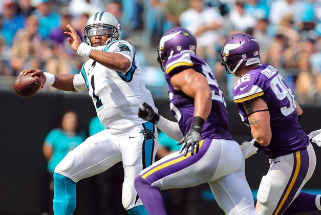 Sep 25, 2016; Charlotte, NC, USA; Carolina Panthers quarterback Cam Newton (1) is chased out of the pocket by Minnesota Vikings outside linebacker Anthony Barr (55) and defensive end Brian Robison (96) during the second half at Bank of America Stadium. Mandatory Credit: Jim Dedmon-USA TODAY Sports