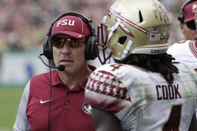In this Saturday, Sept. 24, 2016, photo, Florida State head coach Jimbo Fisher talks to running back Dalvin Cook during the third quarter of an NCAA college football game against South Florida in Tampa, Fla. After firing the most successful coach football coach in the history of the program, LSU needs a home run hire. Fisher is a former LSU assistant who Tigers boosters covet. His resume is sterling, includes a national championship, and he is the anti-Les Miles in that he been one of the college football’s best at developing quarterbacks. (AP Photo/Chris O'Meara)