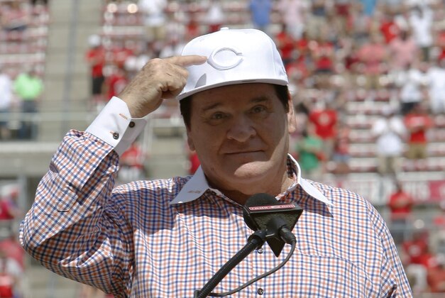 Jun 25, 2016; Cincinnati, OH, USA; Cincinnati Reds former player Pete Rose points to his hat while speaking during his Reds Hall of Fame induction ceremony before a game with the San Diego Padres at Great American Ball Park. Mandatory Credit: David Kohl-USA TODAY Sports