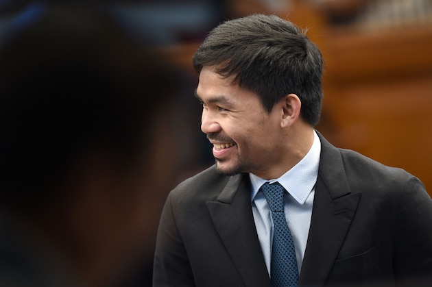 Philippine boxing icon-turned-senator Manny Pacquiao smiles after delivering his previlege speech on restoration of the death penalty during a session at the senate in Manila on August 8, 2016.  
Pacquiao used the Bible to defend restoring the death penalty for drug traffickers as 'approved by God', backing a controversial proposal of President Rodrigo Duterte. / AFP / TED ALJIBE        (Photo credit should read TED ALJIBE/AFP/Getty Images)