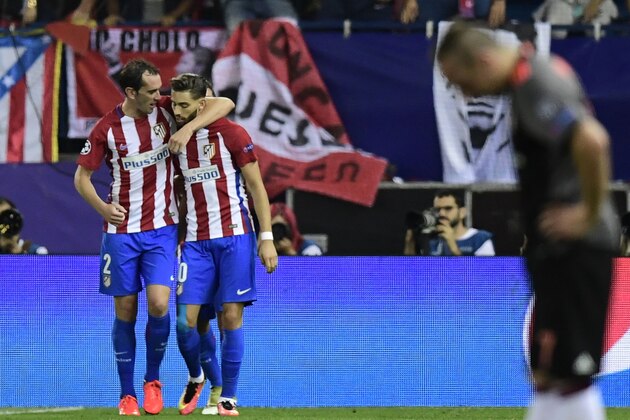 Atletico Madrid's Belgian midfielder Yannick Ferreira Carrasco (R) celebrates with Atletico Madrid's Uruguayan defender Diego Godin after scoring the opener during the UEFA Champions League Group D football match Club Atletico de Madrid vs FC Bayern Munich at the Vicente Calderon stadium in Madrid on September 28, 2016. / AFP / JAVIER SORIANO        (Photo credit should read JAVIER SORIANO/AFP/Getty Images)