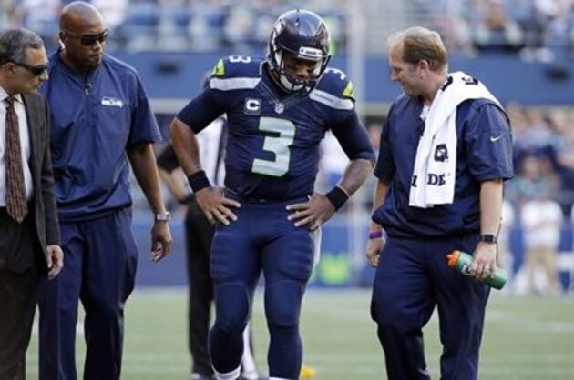Seattle Seahawks quarterback Russell Wilson (3) is assisted off the field after being brought down against the San Francisco 49ers in the second half of an NFL football game, Sunday, Sept. 25, 2016, in Seattle. (AP Photo/Ted S. Warren)