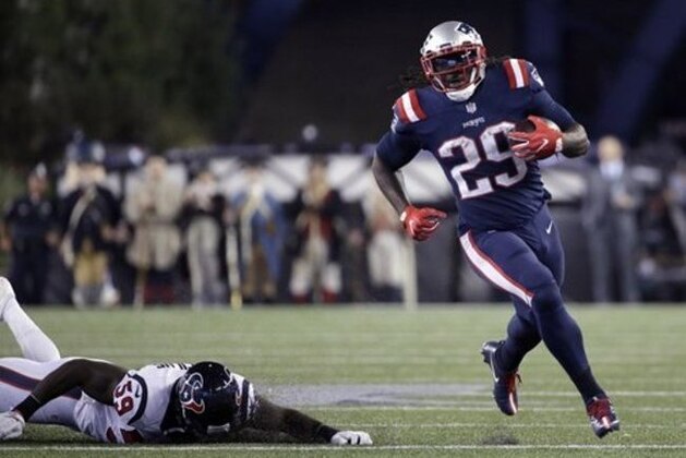 New England Patriots running back LeGarrette Blount (29) runs from Houston Texans linebacker Whitney Mercilus (59) during the second half of an NFL football game Thursday, Sept. 22, 2016, in Foxborough, Mass. (AP Photo/Elise Amendola)