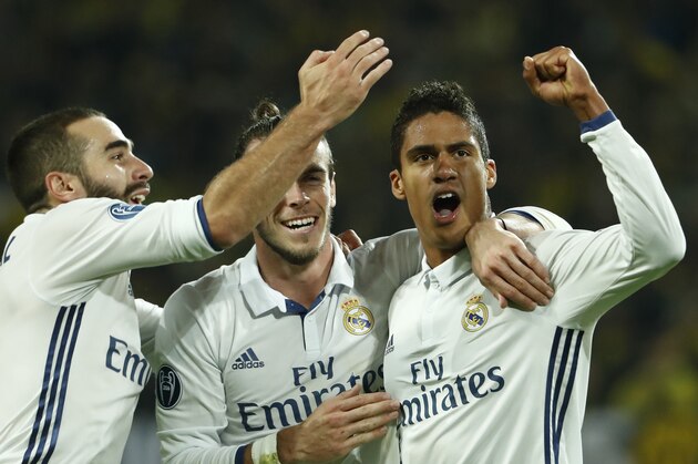 Real Madrid's French defender Raphael Varane (R) reacts after scoring with Real Madrid's Welsh forward Gareth Bale (c) during the UEFA Champions League first leg football match between Borussia Dortmund and Real Madrid at BVB stadium in Dortmund, on September 27, 2016. / AFP / Odd ANDERSEN        (Photo credit should read ODD ANDERSEN/AFP/Getty Images)