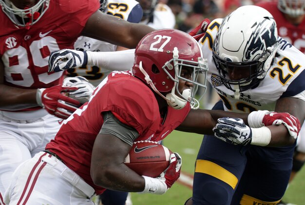 Sep 24, 2016; Tuscaloosa, AL, USA; Alabama Crimson Tide running back Derrick Gore (27) carries the ball and is hit by Kent State Golden Flashes linebacker Jim Jones (22) at Bryant-Denny Stadium. Mandatory Credit: Marvin Gentry-USA TODAY Sports