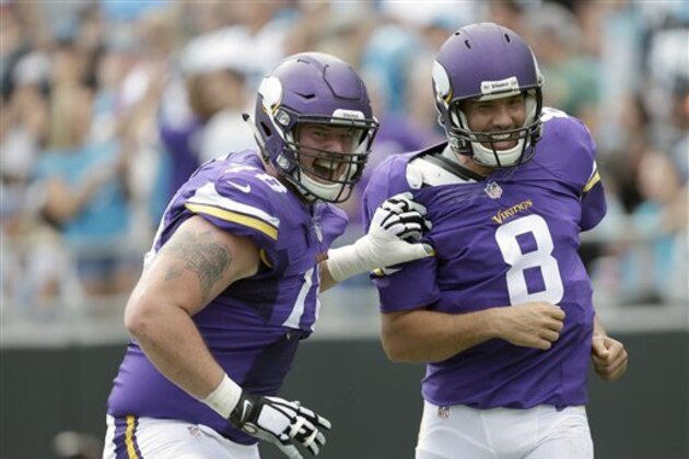 Minnesota Vikings' Jeremiah Sirles (78) celebrates a touchdown with teammate Sam Bradford (8) during the second half of an NFL football game against the Carolina Panthers in Charlotte, N.C., Sunday, Sept. 18, 2016. The Vikings won 22-10. (AP Photo/Bob Leverone)