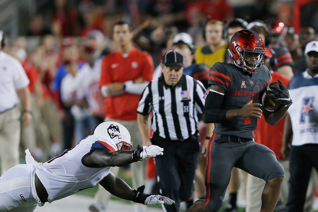 HOUSTON, TX - SEPTEMBER 29: Greg Ward Jr. #1 of the Houston Cougars runs out of bounds as Junior Joseph #11 of the Connecticut Huskies dives for a tackle in the first half on September 29, 2016 in Houston, Texas. (Photo by Bob Levey/Getty Images)
