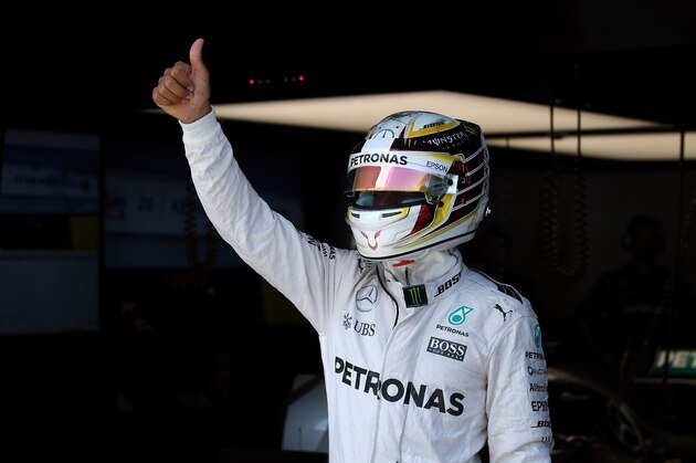 Mercedes AMG Petronas F1 Team's British driver Lewis Hamilton gives a thumps-up at the second practice session of the Formula One Malaysian Grand Prix in Sepang on September 30, 2016.  / AFP / MANAN VATSYAYANA        (Photo credit should read MANAN VATSYAYANA/AFP/Getty Images)