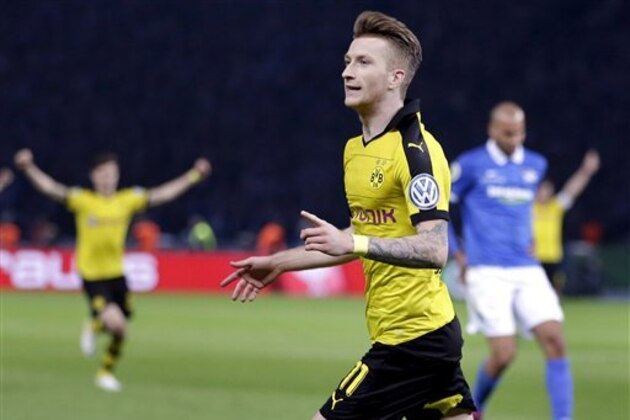 Dortmund's Marco Reus, front, celebrates after scoring his side's 2nd goal during the German soccer cup (DFB Pokal) semifinal match between Hertha BSC Berlin and Borussia Dortmund in Berlin, Germany, Wednesday, April 20, 2016. (AP Photo/Michael Sohn)