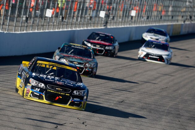 LOUDON, NH - SEPTEMBER 25:  Tony Stewart, driver of the #14 Code 3 Associates/Mobil 1 Chevrolet, leads a pack of cars during the NASCAR Sprint Cup Series Bad Boy Off Road 300 at New Hampshire Motor Speedway on September 25, 2016 in Loudon, New Hampshire.  (Photo by Matt Sullivan/Getty Images)