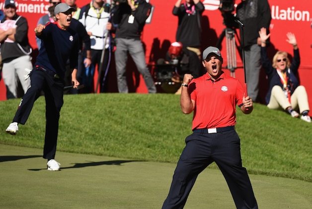 TOPSHOT - Team USA Patrick Reed (R) reacts with teammate Jordan Spieth after winning their match against Team Europe Justin Rose and Henrik Stenson on the 16th green during the Morning Foursome matches at the 41st Ryder Cup at Hazeltine National Golf Course in Chaska, Minnesota, September 30, 2016 / AFP / TIMOTHY A. CLARY        (Photo credit should read TIMOTHY A. CLARY/AFP/Getty Images)