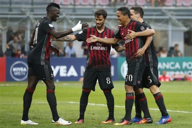 AC Milan's Carlos Bacca, second from right, celebrates with his teammates, from left, Mbaye Niang, Suso and Jack Bonaventura after scoring his side's second goal during the Serie A soccer match between AC Milan and Torino at the San Siro stadium in Milan, Italy, Sunday, Aug. 21, 2016. (AP Photo/Antonio Calanni)