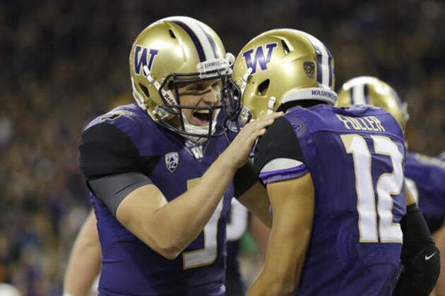 Washington quarterback Jake Browning, left, celebrates with wide receiver Aaron Fuller (12) after Fuller caught a pass from Browning for a touchdown during the second half of an NCAA college football game against Stanford on Friday, Sept. 30, 2016, in Seattle. (AP Photo/Ted S. Warren)